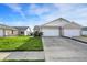Street view of a brick townhouse featuring an attached garage and a neatly kept green lawn at 793 Shepherds Way, Greenwood, IN 46143