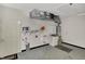 Organized garage featuring utility sink, shelving, water heater and ample space for parking and storage at 793 Shepherds Way, Greenwood, IN 46143