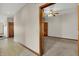 Hallway featuring tile flooring and natural wood trim leading into a carpeted bedroom at 793 Shepherds Way, Greenwood, IN 46143