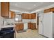 Kitchen with tile flooring, wooden cabinets, white appliances and window over sink at 793 Shepherds Way, Greenwood, IN 46143