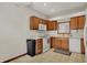 Kitchen with wooden cabinets, tile flooring, white appliances and sink window at 793 Shepherds Way, Greenwood, IN 46143
