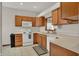Functional kitchen with wooden cabinets, white appliances and tile flooring at 793 Shepherds Way, Greenwood, IN 46143
