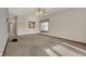 Open living room with neutral carpet and window with decorative curtain at 793 Shepherds Way, Greenwood, IN 46143