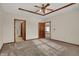 Spacious main bedroom with neutral carpet, ceiling fan and tray ceiling detail at 793 Shepherds Way, Greenwood, IN 46143