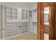 Spacious walk-in closet with custom white shelving and drawers for optimal organization at 793 Shepherds Way, Greenwood, IN 46143
