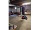 Unfinished basement with stone accent wall, hanging punching bag, and open storage space at 798 S 600 W, New Palestine, IN 46163