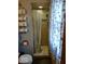 Bathroom featuring a tiled shower with a curtain, towel rack, and neutral decor at 798 S 600 W, New Palestine, IN 46163