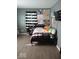 A cozy bedroom featuring a window with plants and patterned curtains and decor at 798 S 600 W, New Palestine, IN 46163
