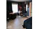 Cozy bedroom with neutral wood flooring, black furniture and decorations, and bright light from the large window at 798 S 600 W, New Palestine, IN 46163