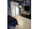 Well-lit bedroom featuring wood flooring, closet with sliding doors, and tv with shelving at 798 S 600 W, New Palestine, IN 46163