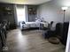 Cozy bedroom with wood-look floors, chair, and a bright window at 798 S 600 W, New Palestine, IN 46163