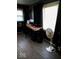 Cozy bedroom with neutral wood flooring, black furniture and decorations, and bright light from the large windows at 798 S 600 W, New Palestine, IN 46163