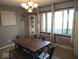 Cozy dining room featuring a wooden table set and large windows providing ample natural light at 798 S 600 W, New Palestine, IN 46163