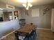 Dining room boasts stylish light fixture, decor, and wood-look floors at 798 S 600 W, New Palestine, IN 46163