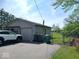 Garage with parking, handicap parking sign, adjacent chain link fenced yard, and residential trash containers at 798 S 600 W, New Palestine, IN 46163