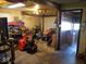 Overstuffed garage with workbench, lawn tractor, and snowblower with access door into main house at 798 S 600 W, New Palestine, IN 46163