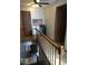 Hallway with wood railing and wood flooring leading to other rooms at 798 S 600 W, New Palestine, IN 46163