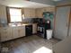 Kitchen with white cabinets, stainless steel stove, and wood-look floors at 798 S 600 W, New Palestine, IN 46163