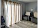 Bright living room with large curtains, comfortable seating, and hardwood floors at 798 S 600 W, New Palestine, IN 46163