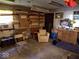 Cozy workshop with seating and work bench, including finished lumber, tools, and a vintage automotive sign at 798 S 600 W, New Palestine, IN 46163