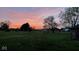 Sunset view of this open backyard with many trees at 798 S 600 W, New Palestine, IN 46163