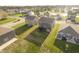 Aerial view of a neighborhood with neat lawns and modern houses, including backyard with trampoline at 813 Sonoma Ln, Greenfield, IN 46140