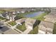 Aerial view of a residential neighborhood featuring well-maintained homes, green spaces, and a scenic pond at 813 Sonoma Ln, Greenfield, IN 46140
