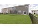 Grassy backyard featuring a trampoline, patio area, and privacy fence; great for entertaining! at 813 Sonoma Ln, Greenfield, IN 46140