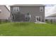 Grassy backyard featuring a trampoline and patio area; perfect for outdoor living! at 813 Sonoma Ln, Greenfield, IN 46140