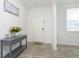 Bright entryway with gray console table, decorative accents, and hardwood floors, creating a welcoming atmosphere at 813 Sonoma Ln, Greenfield, IN 46140