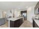 Open-concept kitchen featuring a large island, stainless steel appliances, and seamless flow into the living area at 813 Sonoma Ln, Greenfield, IN 46140