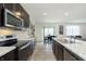Stylish kitchen with stainless steel appliances, dark cabinetry, granite countertops, and an open layout at 813 Sonoma Ln, Greenfield, IN 46140