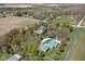 An aerial view of a property with a home, pool, outbuilding, and surrounding greenery in a countryside setting at 8551 E 300 S, Zionsville, IN 46077