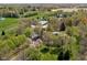 Picturesque aerial view of a vast property, highlighting lush green fields, mature trees, and an elegant home at 8551 E 300 S, Zionsville, IN 46077