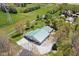 Aerial view of a large outbuilding featuring multiple garage doors and surrounded by a gravel driveway and green space at 8551 E 300 S, Zionsville, IN 46077