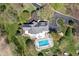 A luxurious home with a backyard pool, patio, and meticulously landscaped gardens viewed from above at 8551 E 300 S, Zionsville, IN 46077