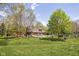 Expansive backyard featuring a pool, mature trees, and a secure fence, ideal for outdoor activities at 8551 E 300 S, Zionsville, IN 46077