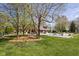 Well-manicured backyard featuring lush green grass, mature trees, and an in-ground pool at 8551 E 300 S, Zionsville, IN 46077