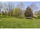 Spacious backyard with mature trees and a trampoline, perfect for outdoor activities at 8551 E 300 S, Zionsville, IN 46077