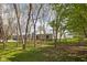 Exterior shot of a large barn with green trim, surrounded by mature trees at 8551 E 300 S, Zionsville, IN 46077