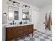 Bathroom featuring a double vanity, checkerboard floor, and framed mirrors, offering a stylish and functional design at 8551 E 300 S, Zionsville, IN 46077