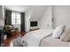 Bedroom with dark wood floors, large window with view, and comfortable chair for reading, promoting relaxation at 8551 E 300 S, Zionsville, IN 46077