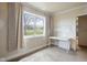 Bright bedroom with a large window offering views of a fenced yard and a white table at 8551 E 300 S, Zionsville, IN 46077