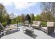 Outdoor deck featuring comfortable seating with views of the lush backyard and inviting in-ground pool at 8551 E 300 S, Zionsville, IN 46077