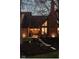 Charming brick home featuring a welcoming front entrance, well-manicured landscaping, and illuminated walkway at 8551 E 300 S, Zionsville, IN 46077