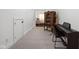 Hallway with carpet, piano, and antique cabinet leading to a bedroom, offering a blend of classic and modern elements at 8551 E 300 S, Zionsville, IN 46077