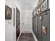 Hallway features wainscotting, with an array of art, and a dark rug that adds elegance and character to the space at 8551 E 300 S, Zionsville, IN 46077