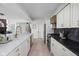Well-appointed kitchen with marble countertops, stainless steel appliances, and white cabinetry at 8551 E 300 S, Zionsville, IN 46077