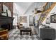 Inviting living room boasts a soaring brick fireplace, cozy seating, and an open staircase for a grand appeal at 8551 E 300 S, Zionsville, IN 46077