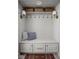 Cozy mudroom features built-in bench with storage, hooks, lights, and decor pillows for a functional space at 8551 E 300 S, Zionsville, IN 46077